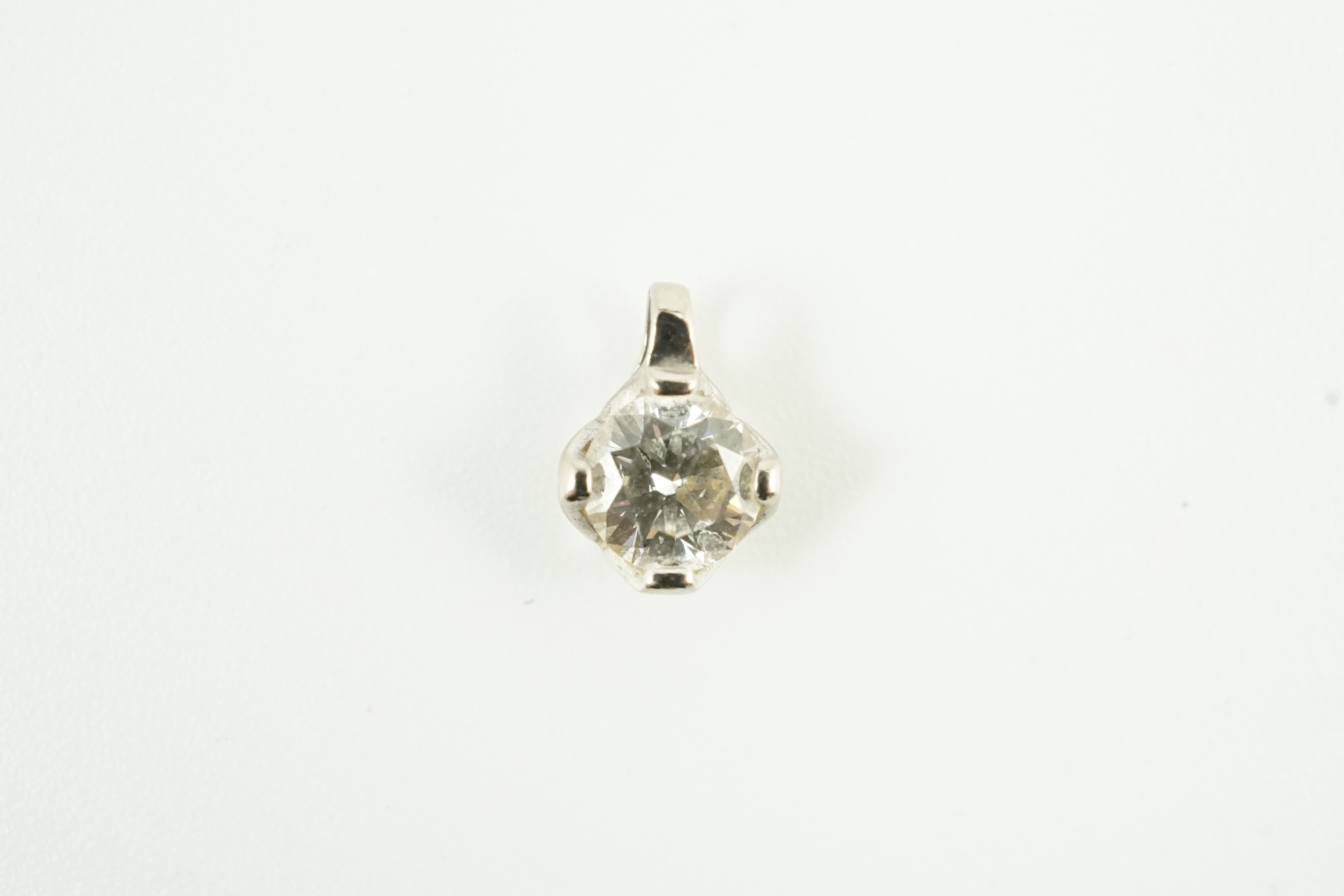 A modern 18ct white gold and solitaire diamond set pendant, gross weight 0.4 grams, stone diameter 5.1mm.